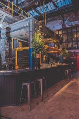 A bar wraps around original pipework. (Courtesy of Birchtree Catering/BeauMonde Originals)