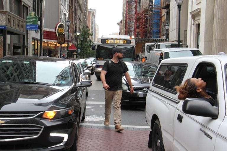 a-pedestrian-threads-his-way-through-snarled-traffic-at-broad-and-chestnut-streets-emma-lee-whyy.original A pedestrian threads his way through snarled traffic at Broad and Chestnut streets. (Emma Lee/WHYY)