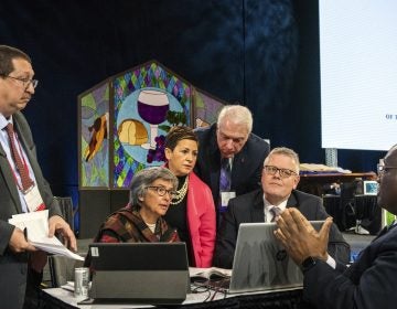 Leaders from the United Methodist Church confer during the 2019 Special Session of the General Conference of The United Methodist Church in St. Louis, Mo. America's second-largest Protestant denomination faces a likely fracture as delegates voted to strengthen bans on same-sex marriage and ordination of LGBT clergy. (Sid Hastings/AP)