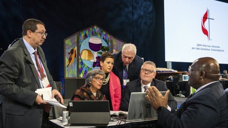 Leaders from the United Methodist Church confer during the 2019 Special Session of the General Conference of The United Methodist Church in St. Louis, Mo. America's second-largest Protestant denomination faces a likely fracture as delegates voted to strengthen bans on same-sex marriage and ordination of LGBT clergy. (Sid Hastings/AP)