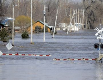 A railroad crossing is flooded with water from the Platte River in Plattsmouth, Neb. Record high floodwaters inundated regions of the Midwest following an intense winter storm and rapid snowmelt.
(Nati Harnik/AP Photo)