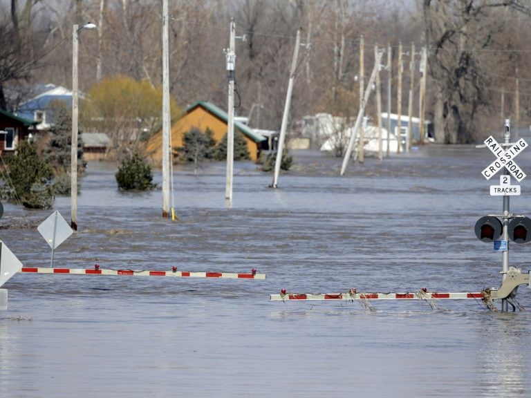 A railroad crossing is flooded with water from the Platte River in Plattsmouth, Neb. Record high floodwaters inundated regions of the Midwest following an intense winter storm and rapid snowmelt.
(Nati Harnik/AP Photo)