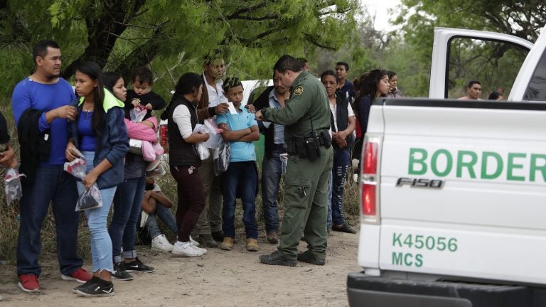 A Border Patrol agent checks the names and documents of families who crossed the nearby U.S.-Mexico border near McAllen, Texas. Immigration authorities say they expect the continuing surge of Central American families crossing the border to multiply in the coming months. A Border Patrol agent checks the names and documents of families who crossed the nearby U.S.-Mexico border near McAllen, Texas. Immigration authorities say they expect the continuing surge of Central American families crossing the border to multiply in the coming months. (Eric Gay/AP Photo)