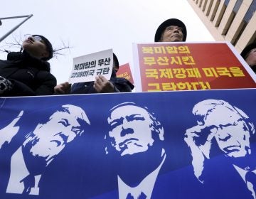 Protesters hold a banner showing images, of President Trump, Secretary of State Mike Pompeo, and National Security Adviser John Bolton during a rally against U.S. sanctions on North Korea, near the U.S. Embassy in Seoul, South Korea. (Ahn Young-joon/AP)