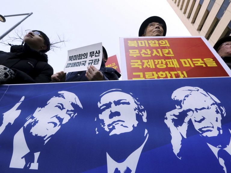 Protesters hold a banner showing images, of President Trump, Secretary of State Mike Pompeo, and National Security Adviser John Bolton during a rally against U.S. sanctions on North Korea, near the U.S. Embassy in Seoul, South Korea. (Ahn Young-joon/AP)