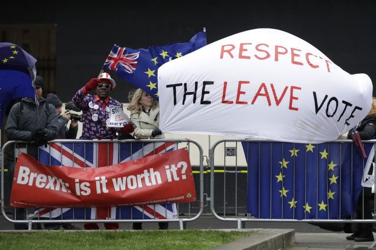 Pro-Brexit leave the European Union supporters and anti-Brexit remain in the European Union supporters take part in a protest outside the Houses of Parliament in London, Tuesday, March 12, 2019. British Prime Minister Theresa May faced continued opposition to her European Union divorce deal Tuesday despite announcing what she described as 