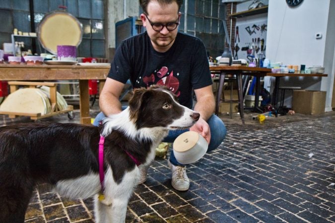 Brian Giniewski and his dog Jelly who has her own line of dog bowls. (Kimberly Paynter/WHYY)