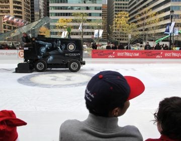 A zamboni puts a fresh gloss on the Dilworth Plaza ice rink.