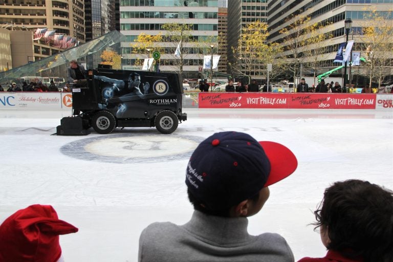 A zamboni puts a fresh gloss on the Dilworth Plaza ice rink.