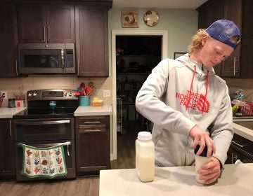 Jonah Reeder prepares a special protein shake that helps him manage a metabolic condition called phenylketonuria. (Julia Ritchey/KUER)