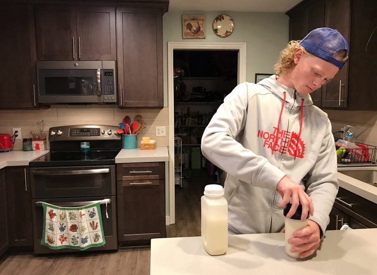 Jonah Reeder prepares a special protein shake that helps him manage a metabolic condition called phenylketonuria. (Julia Ritchey/KUER)