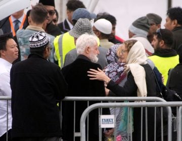 A mourner comforts John Milne (center), the father of 14-year-old Sayyad Milne, during the boy's funeral in Christchurch, New Zealand, on Thursday. Sayyad Milne was one of 50 people killed at two mosques last Friday. (Marty Melville/AFP/Getty Images)