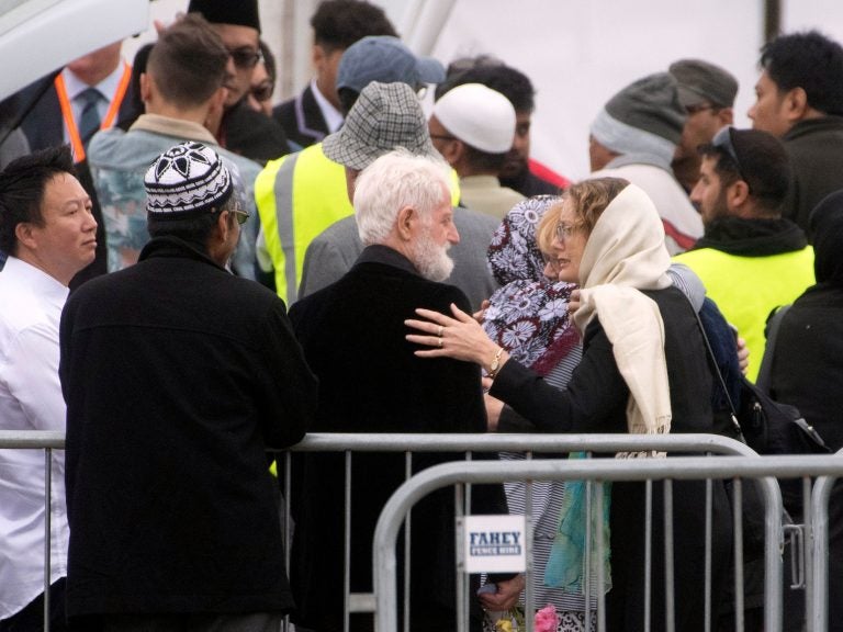 A mourner comforts John Milne (center), the father of 14-year-old Sayyad Milne, during the boy's funeral in Christchurch, New Zealand, on Thursday. Sayyad Milne was one of 50 people killed at two mosques last Friday. (Marty Melville/AFP/Getty Images)