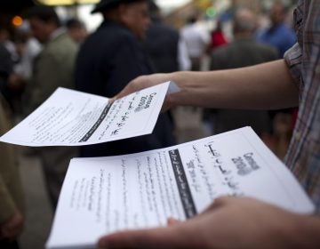Worshippers exiting a mosque in the Bay Ridge neighborhood of Brooklyn, N.Y., are handed fliers encouraging participation in the 2010 census. (Robert Nickelsberg/Getty Images)