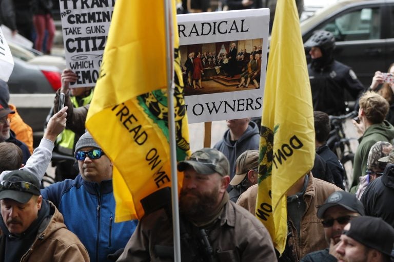 Protestors carry signs as they attend a rally on Monday, Jan. 7, 2019, in Pittsburgh. The protesters, many openly carrying guns, gathered in downtown Pittsburgh to rally against the city council's proposed restrictions and banning of semi-automatic rifles, certain ammunition and firearms accessories within city limits. (Keith Srakocic/AP Photo)