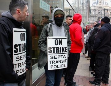 About 30 SEPTA police officers picket outside SEPTA headquarters at 1234 Market Street. (Emma Lee/WHYY)