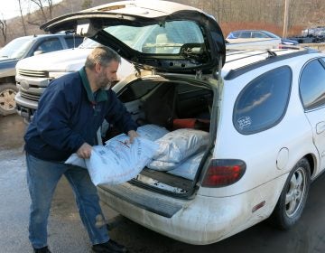 John Ord of Susquehanna, Pa., loads 40-pound bags of anthracite coal into his car. He's among the fewer than 130,000 households left in the United States that burn coal to heat their homes. (Jeff Brady/NPR)
