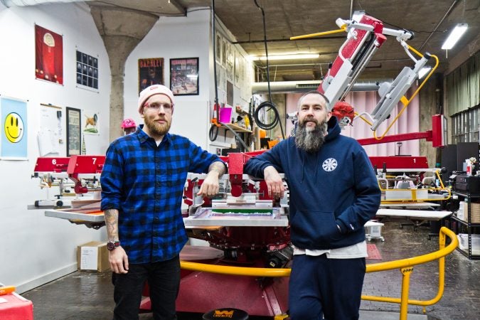 Dylan Houser (left) and Mason Warner are two of the owners of Pink’s Inks, located in the Globe Dye Works building. (Kimberly Paynter/WHYY)