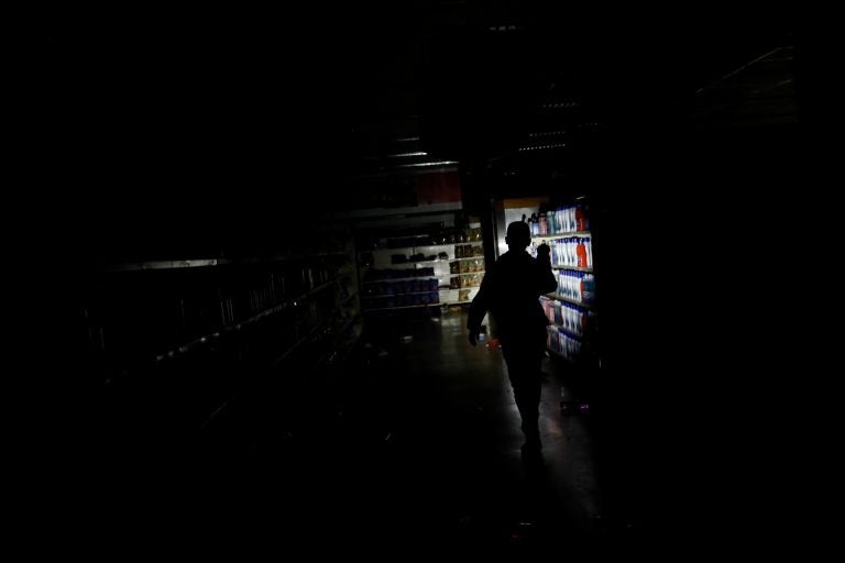 A worker inspects damage in a supermarket in Caracas on Sunday after it was looted during a days-long blackout in Venezuela. A worker inspects damage in a supermarket in Caracas on Sunday after it was looted during a days-long blackout in Venezuela.
(Carlos Garcia Rawlins/Reuters)