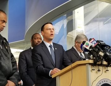 Pennsylvania Attorney General Josh Shapiro speaks to reporters with Police Commissioner Richard Ross (left) and District Attorney Larry Krasner at his side (Tom MacDonald/WHYY)