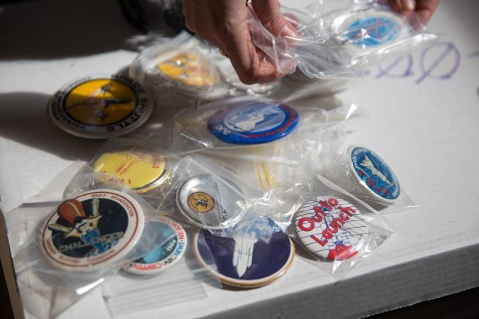 Pins and buttons from French journalist Jacques Tiziou’s collection of memorabilia from the space program. (Lindsay Lazarski/WHYY)