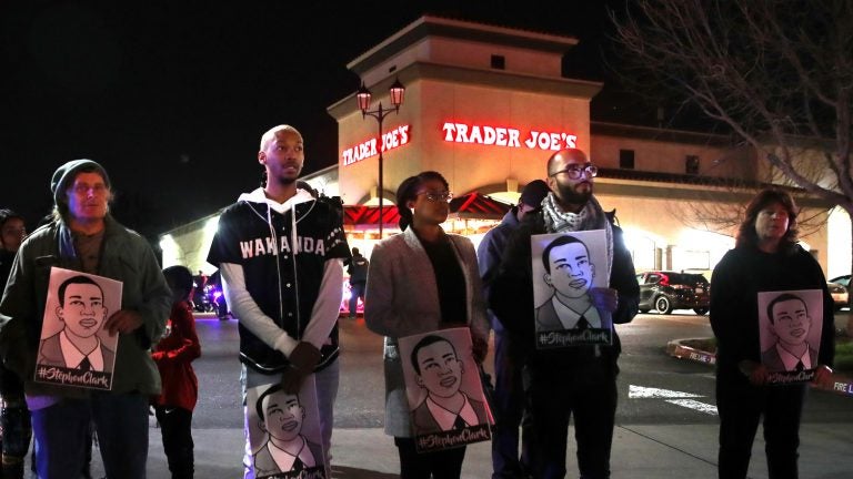 Demonstrators stand near a Trader Joe's grocery Monday night, protesting the decision to not charge Sacramento police officers who shot and killed Stephon Clark last year. Protesters also marched into a nearby neighborhood; police arrested 84 people. (Justin Sullivan/Getty Images)