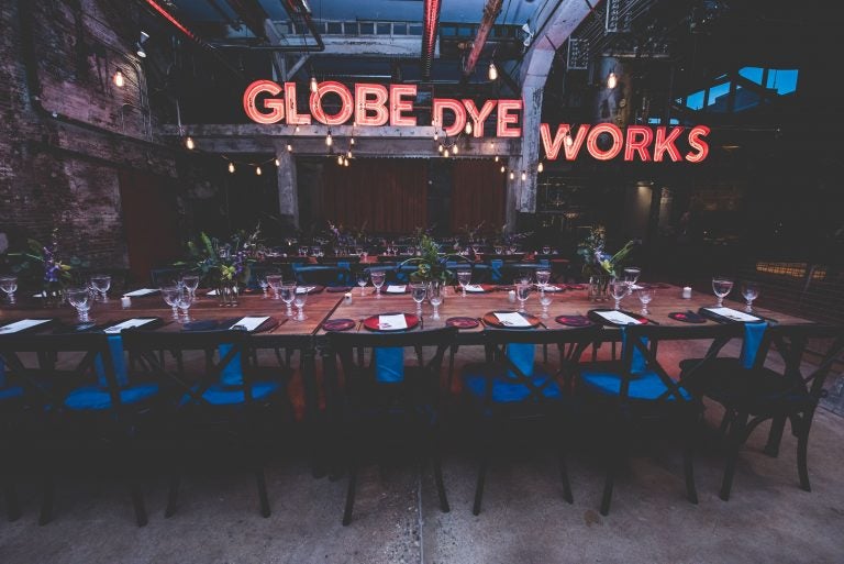The original Globe Dye Works sign now takes center stage in the former boiler room. (Courtesy of Birchtree Catering/BeauMonde Originals)