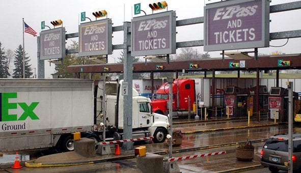 Trucks and cars move through a Pennsylvania Turnpike toll plaza in Carlisle