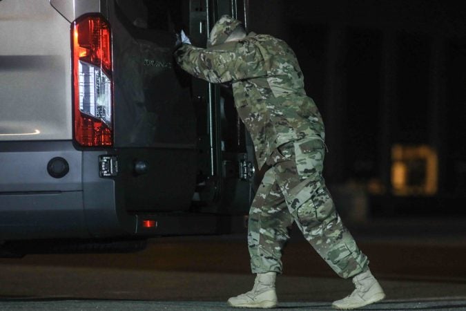 A U.S. Marine completes the transfer of the remains of Staff Sgt. Christopher K.A. Slutman during a dignified transfer at Dover Air Force Base Thursday, Apr. 11, 2019,

Sgt. Slutman died April 8 while conducting combat operations in Parwan province, Afghanistan. (Saquan Stimpson for WHYY)