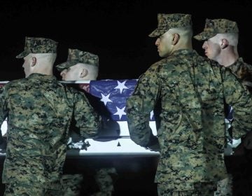 A U.S. Marine Corps carry team transfers the remains of Staff Sgt. Christopher K.A. Slutman, 43, of Newark, Delaware, during a dignified transfer at Dover Air Force Base Thursday, Apr. 11, 2019,  in Dover, DE. Sgt. Slutman died April 8 while conducting combat operations in Parwan province, Afghanistan. (Saquan Stimpson for WHYY)