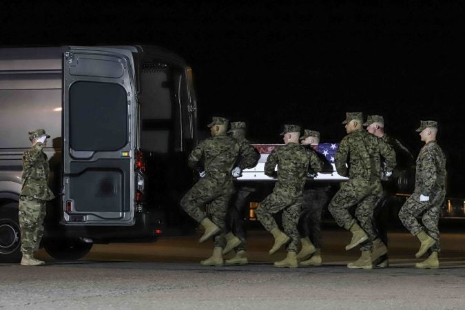 U.S. Marines carry the remains of Staff Sgt. Christopher K.A. Slutman during a dignified transfer at Dover Air Force Base Thursday, Apr. 11, 2019. (Saquan Stimpson for WHYY)