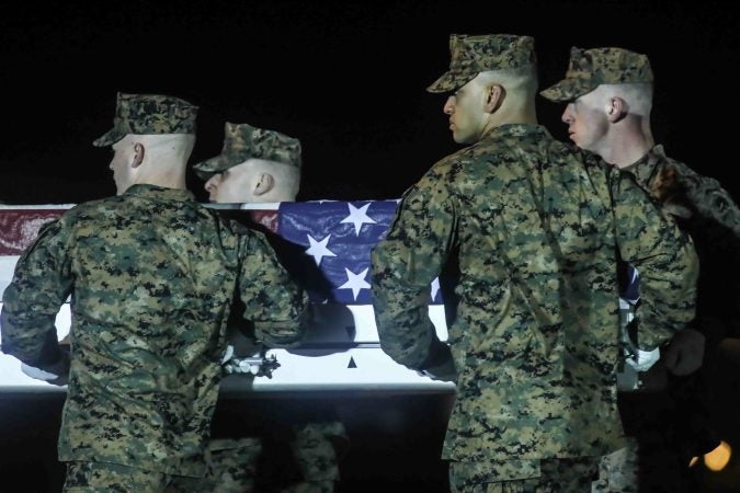 U.S. Marines carry the remains of Staff Sgt. Christopher K.A. Slutman during a dignified transfer at Dover Air Force Base Thursday, Apr. 11, 2019. (Saquan Stimpson for WHYY)