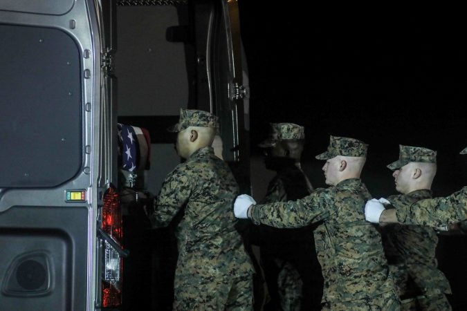 U.S. Marines carry the remains of Staff Sgt. Christopher K.A. Slutman during a dignified transfer at Dover Air Force Base Thursday, Apr. 11, 2019. (Saquan Stimpson for WHYY)