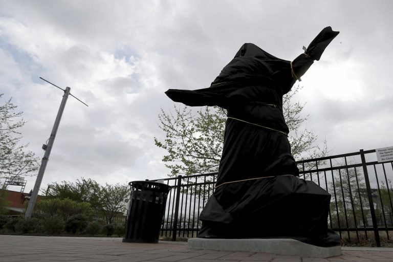 The covered Kate Smith statue sits outside Wells Fargo Center in Philadelphia on Friday, April 19, 2019. (David Maialetti/The Philadelphia Inquirer via AP)