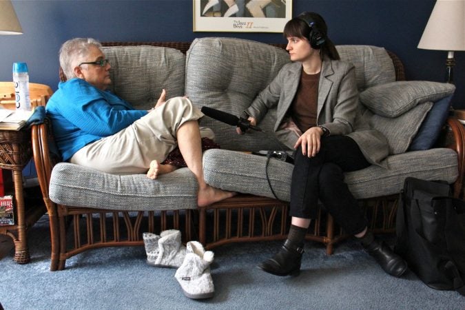 Patricia Cahill used to use a pseudonym when blogging about her experience as a victim of sexual assault, but has become more comfortable in recent years in sharing her story publicly. Here pictured in her Lancaster home with WHYY reporter Laura Benshoff. (Emma Lee/WHYY)