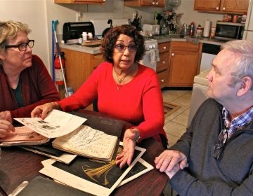 Margaret McGriff (center), widow of jazz organist Jimmy McGriff, shares her trove of papers from her husband's career with Jack McCarthy and Suzanne Cloud of the Philadelphia Jazz Project. (Emma Lee/WHYY)