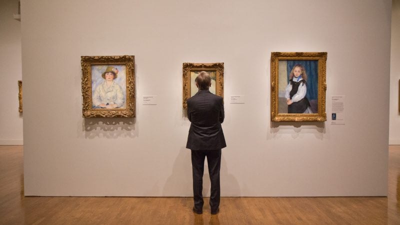 A visitor admires impressionist portraits at “The Impressionist’s Eye” exhibit at the Philadelphia Museum of Art. (Kimberly Paynter/WHYY)