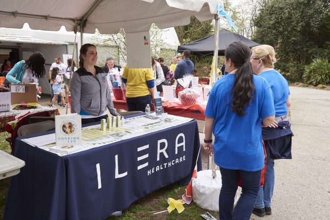 Vendors offer resources, activities, and entertainment for people visiting the 20th Annual Autism Awareness Day event at the Philadelphia Zoo. Ilera is a company which created medical marijuana products for those with Autism. (Natalie Piserchio for WHYY)