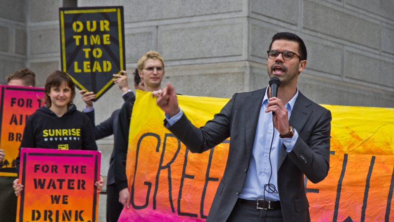 At-large city council candidate Adrian Rivera-Reyes speaks at New Sunrise Movement’s New Green Deal Rally at City Hall Monday. He is a biologist. (Kimberly Paynter/WHYY)