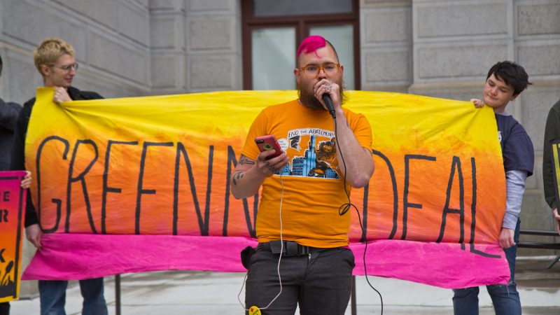 At-large city council candidate Joe Cox speaks at New Sunrise Movement’s New Green Deal Rally at City Hall Monday. (Kimberly Paynter/WHYY)