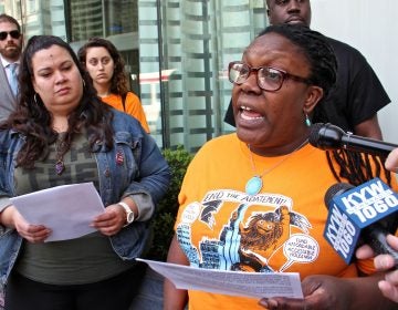 Kendra Brooks (right) with 215  People's Alliance criticizes Philadelphia City Councilman Allan Domb for profiting from the city's 10-year tax abatement program. She is joined by council candidate Erika Almiron (left). (Emma Lee/WHYY)