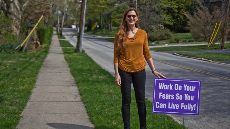 Meg Miller displays positive messages on her lawn and along the road she lives on in Lower Merion, Pa. (Kimberly Paynter/WHYY)