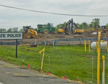 Crews work at the site of a sinkhole along the Mariner East pipeline route near the Pennsylvania State Police barracks on Route 1 in Delaware County on Thursday, April 25, 2019. Pipeline builder said there were no leaks and no pipelines were exposed. (Kimberly Paynter / WHYY)