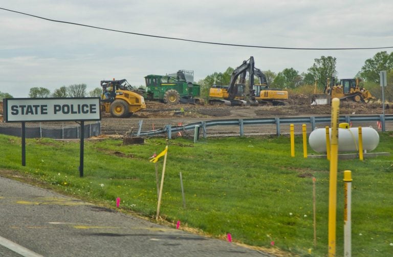 Crews work at the site of a sinkhole along the Mariner East pipeline route near the Pennsylvania State Police barracks on Route 1 in Delaware County on Thursday, April 25, 2019. Pipeline builder said there were no leaks and no pipelines were exposed. (Kimberly Paynter / WHYY)