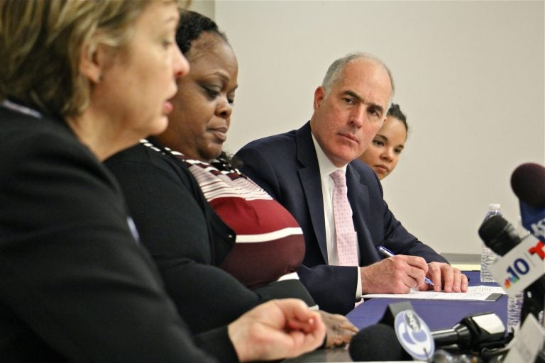 U.S. Sen. Bob Casey takes notes during a discussion at Penn's School of Social Policy and Practice about the importance of reauthorizing the Violence Against Women Act, which expired 70 days ago. (Emma Lee/WHYY)