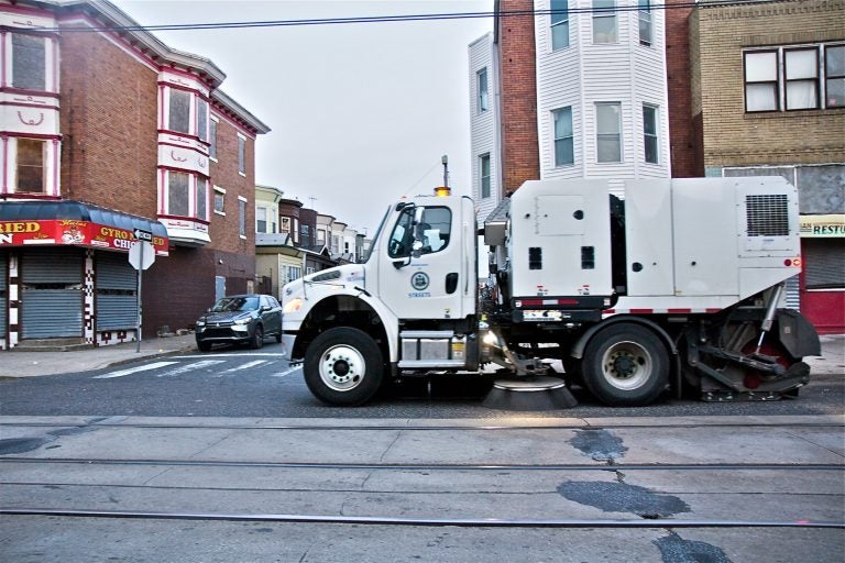 A city street sweeper cleans Chester Avenue in Southwest Philadelphia. (Kimberly Paynter/WHYY)