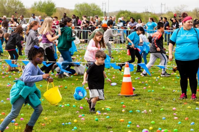 Following the Easter Egg drop children and some adults ran to collect them at the River Fields in Northeast Philadelphia. (Brad Larrison for WHYY)