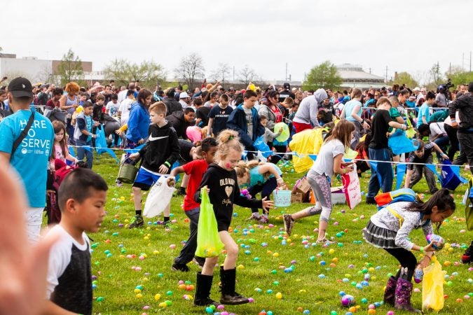 Following the Easter Egg drop children and some adults ran to collect them at the River Fields in Northeast Philadelphia. (Brad Larrison for WHYY)