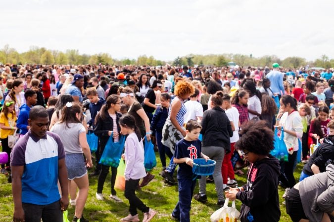 Children search for Easter eggs at the River Fields in Northeast Philadelphia Saturday after a helicopter dropped an estimated 30,000 eggs. (Brad Larrison for WHYY)