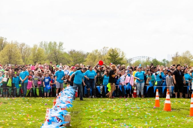 Anticipation grows as a helicopter approached to drop an estimated 30,000 Easter eggs on the River Fields in Northeast Philadelphia Saturday. (Brad Larrison for WHYY)